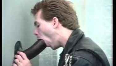 Gay glory hole cock sucking on the toilet
